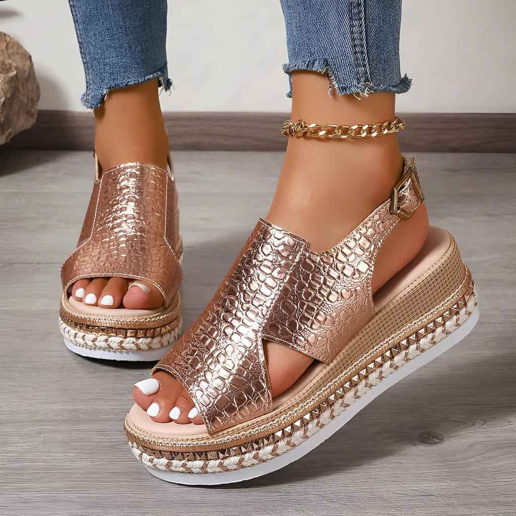 Gold women's Roman sandals with round hollow-out toe and an ankle buckle strap on a rubber sole.