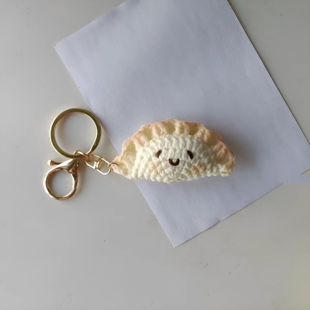 Handmade crochet plush dumpling pendant with keychain in traditional Spring Festival design.