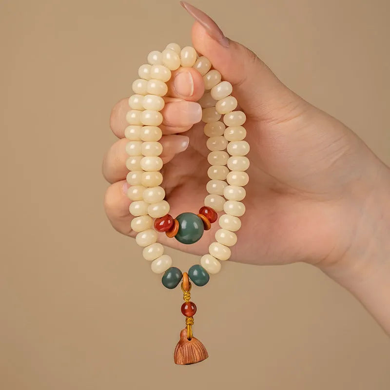 Cream topaz coloured wooden Bodhi root bracelet with flat round beads on a wrist.