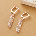 Rectangular two-tone hollow alloy stud earrings for women with electroplated finish.