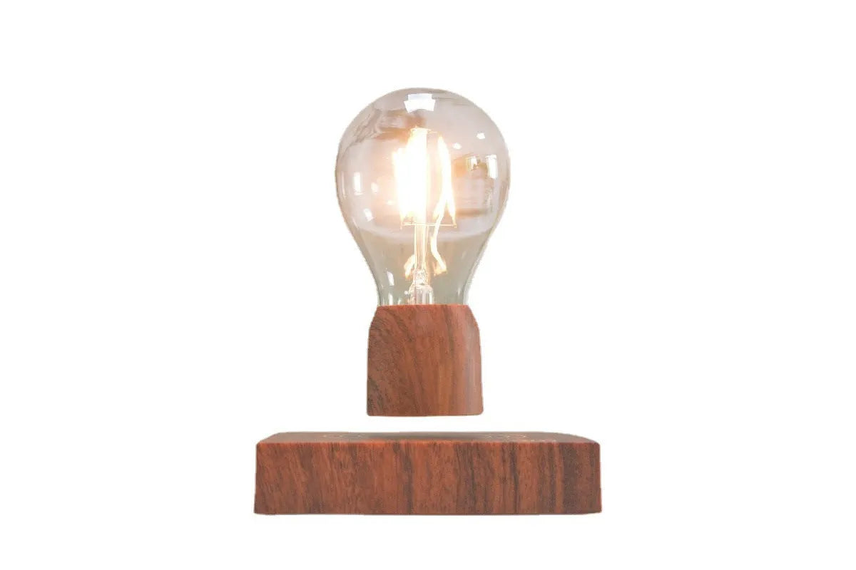 Magnetic levitation desk lamp with floating light bulb on imitation wood base.