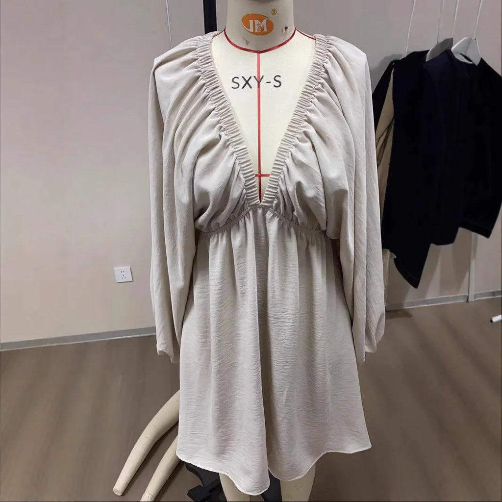 Women's v-neck long sleeve dress with puff sleeves and a flounced swing skirt in polyester fabric.