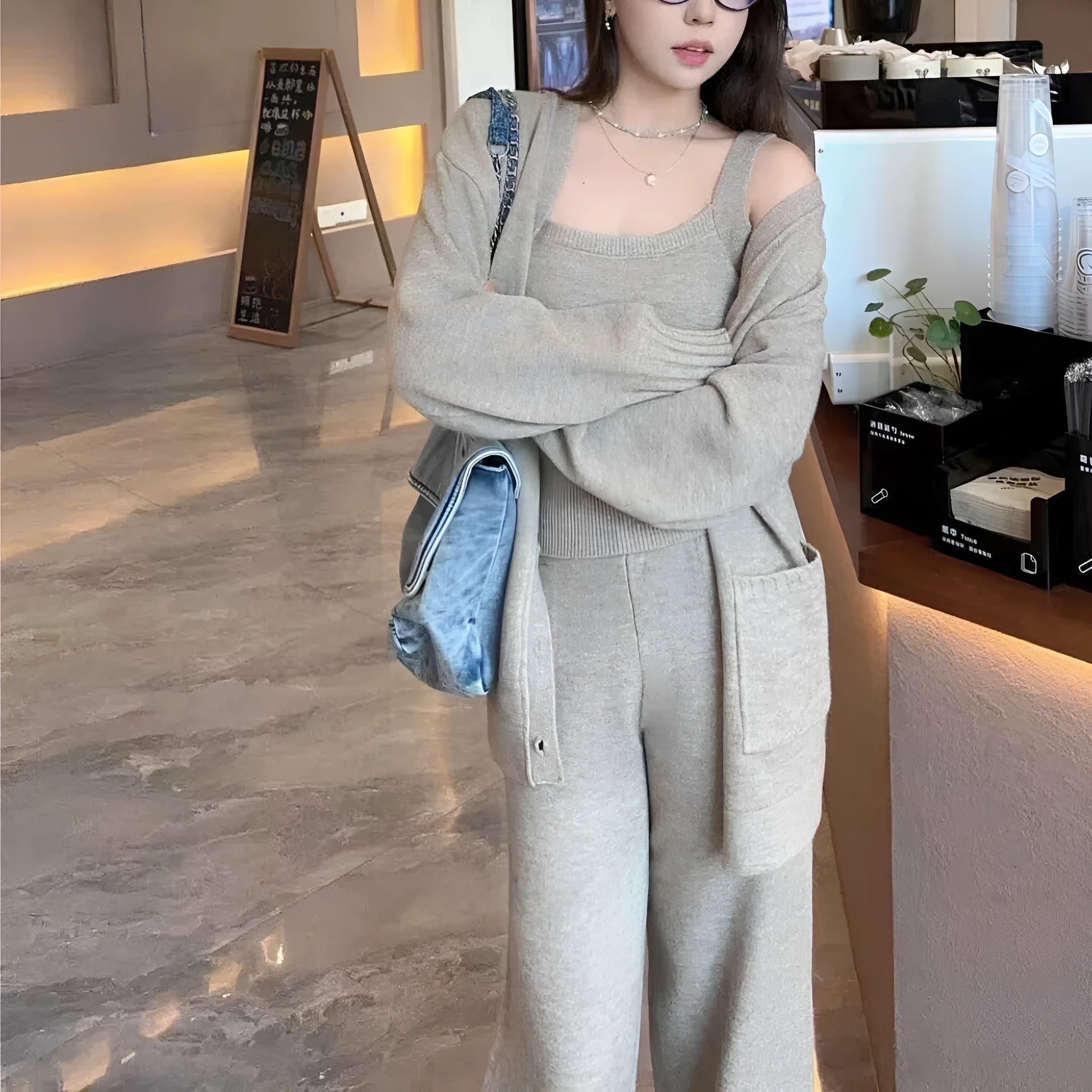 Women's light brown knit cardigan, vest, and casual pants three-piece set laid flat.