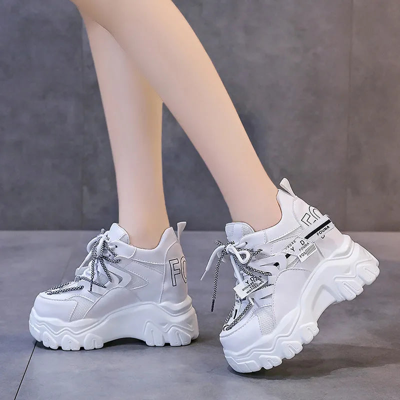Women's white and black breathable mesh platform sports shoes with cross-strap and rubber sole.