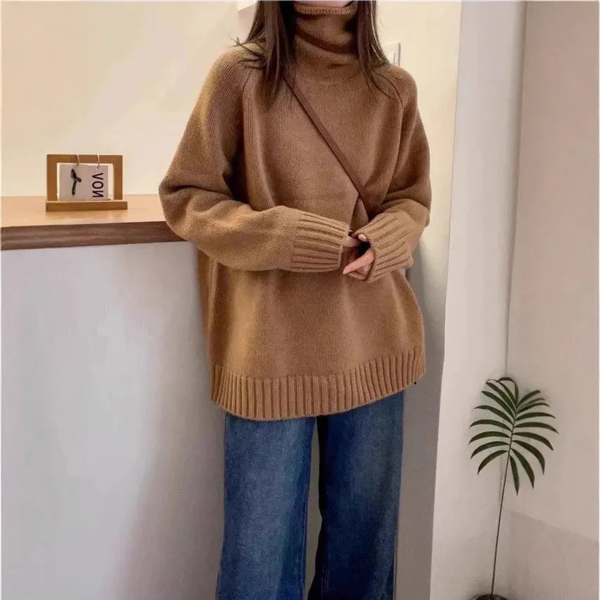 Women's loose grey turtleneck sweater with thick textured pile collar, casual style.