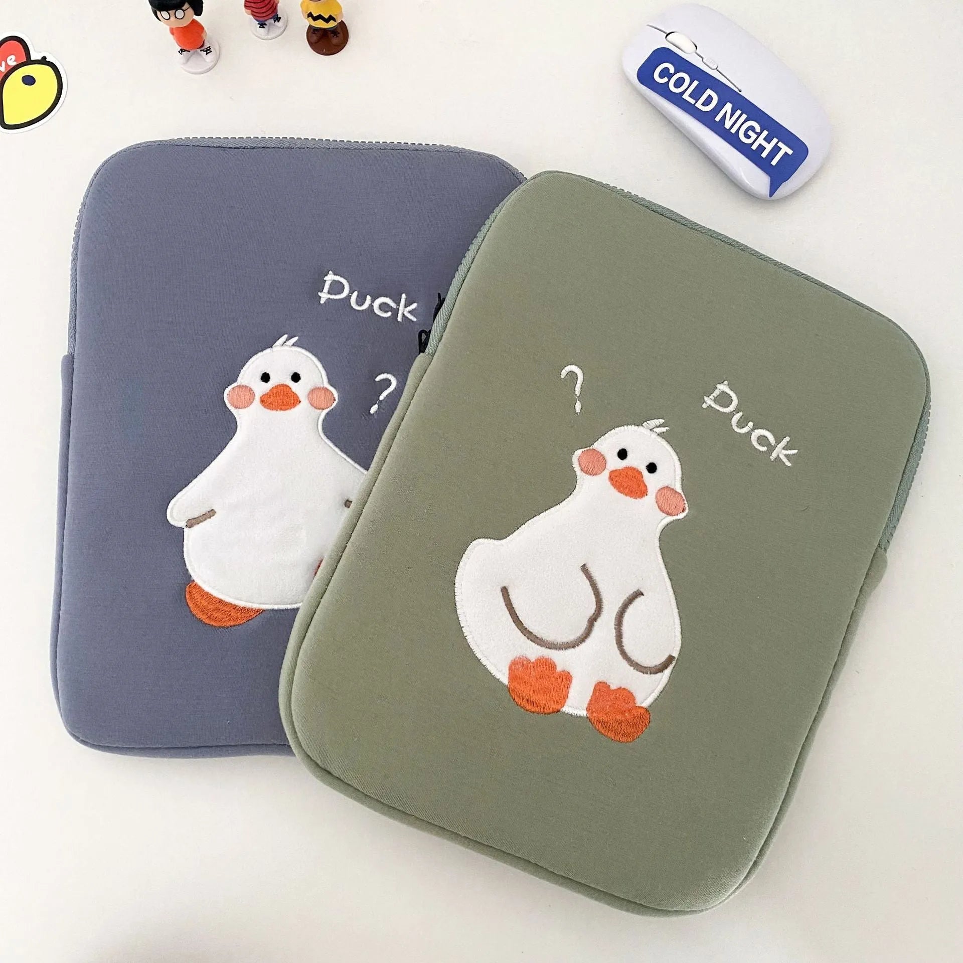 Blue cotton tablet case with embroidered cartoon duck design and a zipper closure.