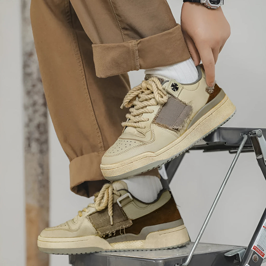 Beige low-top skateboard shoes with vintage patch design and rubber sole