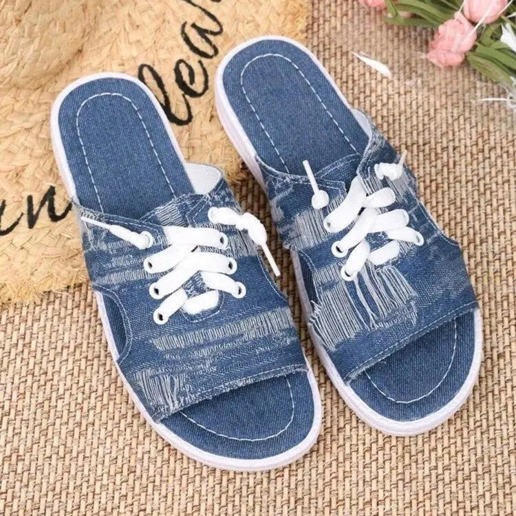 Blue women's Roman-style flat canvas slippers with a cloth upper and rubber sole.
