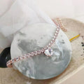 Shiny rhinestone heart-shaped collar for dog or cat in gold, on a size chart showing S, M, L measurements.