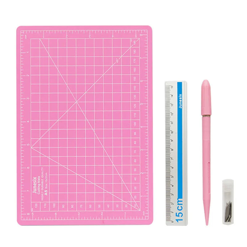 Art pen knife cutting board set in blue, showing plastic backing board with ruler, metal blade, and sharpener.