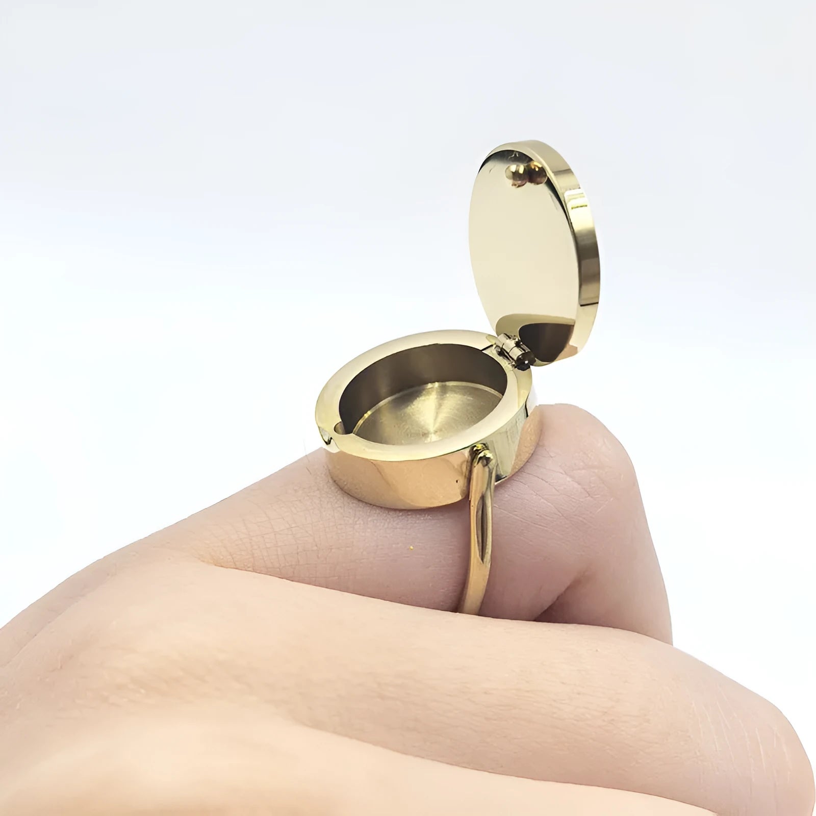 Gold electroplated titanium steel unisex storage ring with future-style round design on a plain background