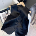 Black satin ladies sleeveless vest with V-neck and loose fit on a hanger.