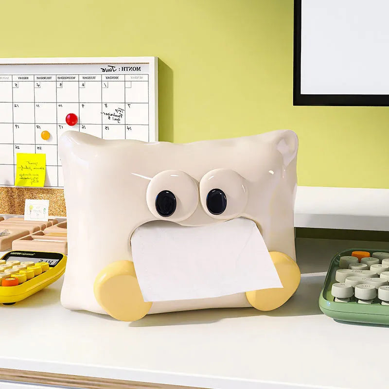 White glazed ceramic tissue box holder on a wooden coffee table.