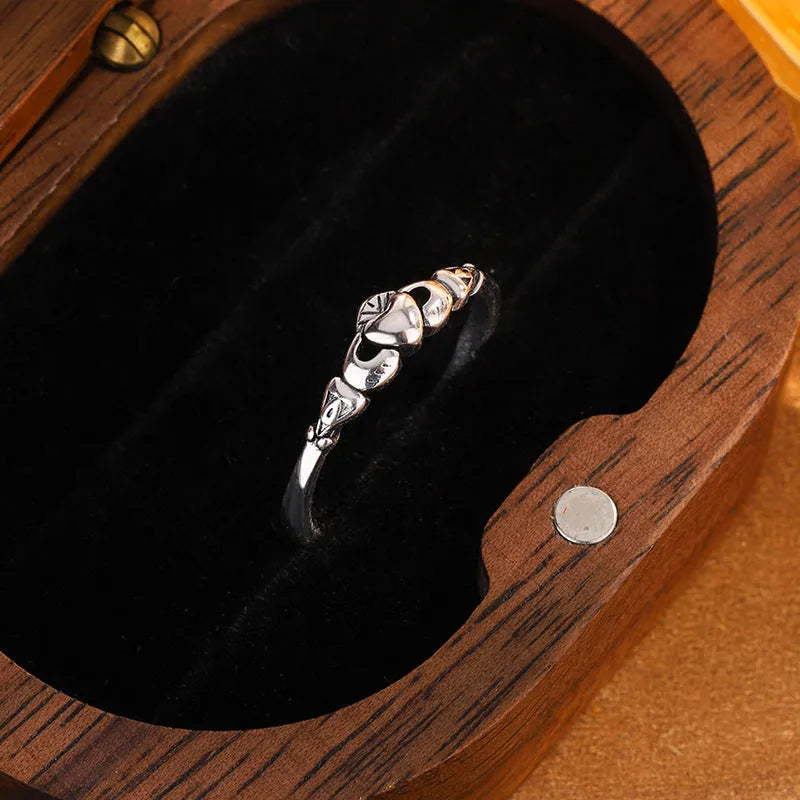 Retro silver women's open ring with a heart shape on a copper band.
