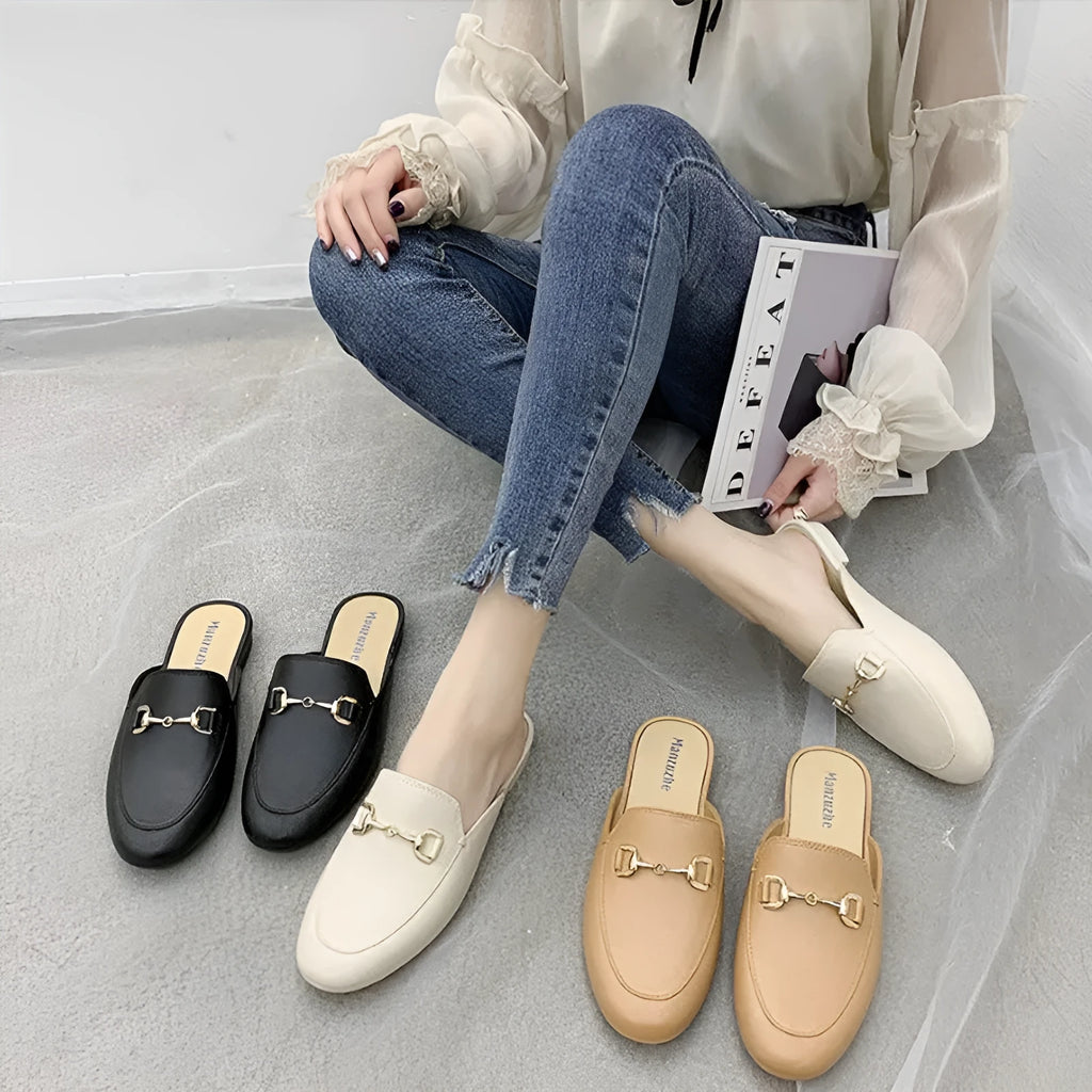 Women's PVC closed toe half slipper in black with a D buckle closure on a white background.