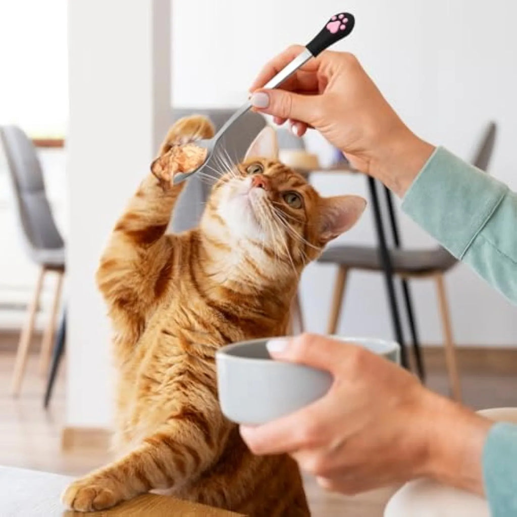 White and black pet food spoons with cat paw prints and silicone grips