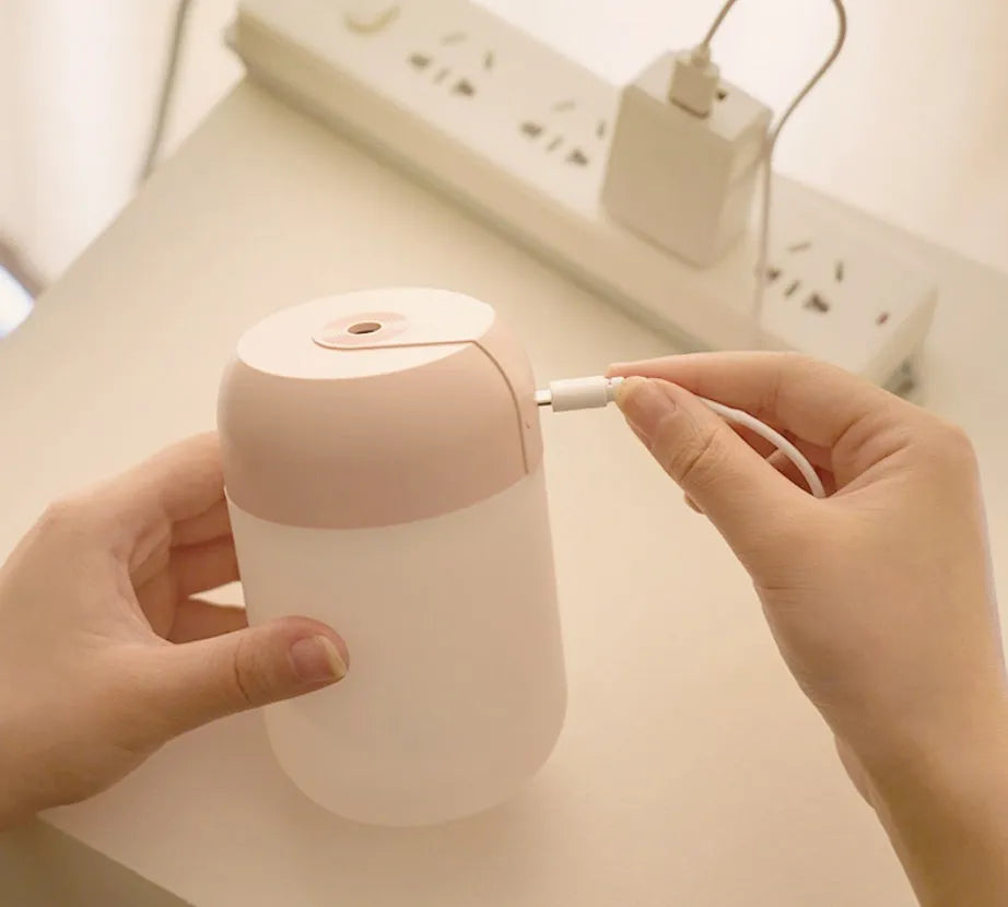Small white cylindrical USB mini humidifier for desk or bedside use.