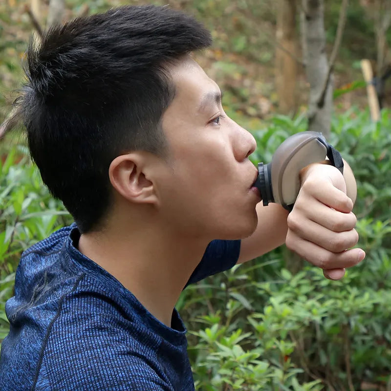 Orange wrist-mounted sports water bottle with Velcro strap showing bite-to-suck silicone mouth