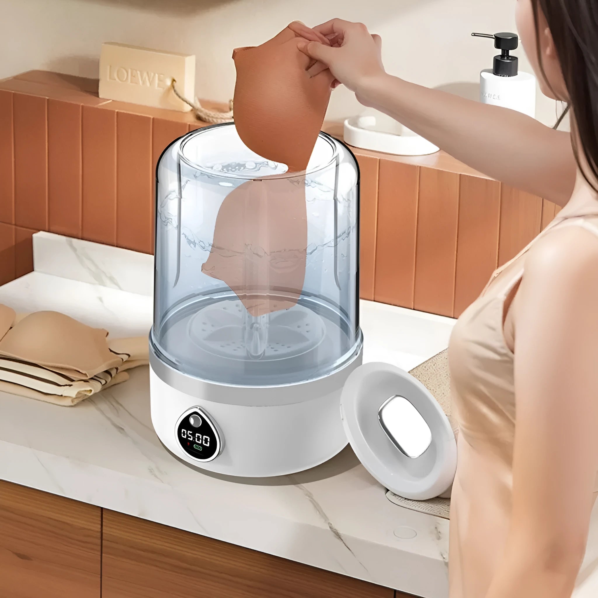 White portable mini washing machine with USB cable on a countertop, showing compact size.