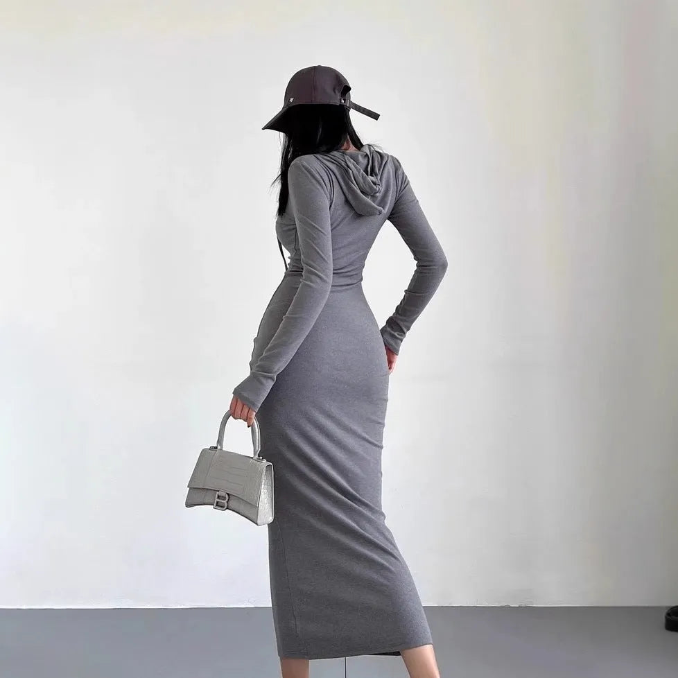 A light grey women's hooded sheath dress with long sleeves and a high waist on a model.