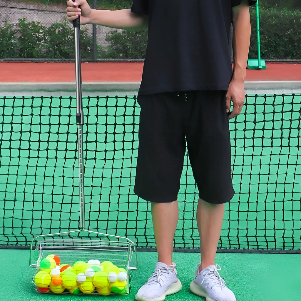 Stainless steel tennis ball roller picker with adjustable handle on a tennis court
