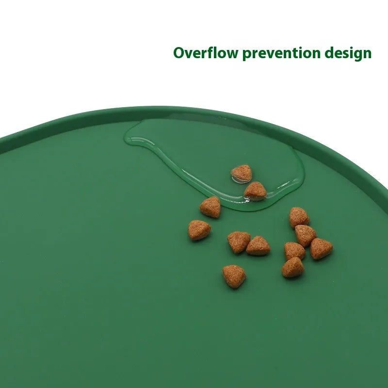 Silicone waterproof cat feeding placemat in beige colour on a floor next to a food bowl.