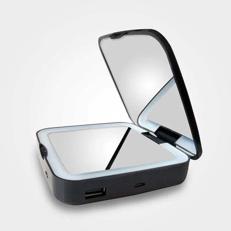 Black and white lighted makeup mirror showing standard and 4x magnifying circles with illuminated ring light.