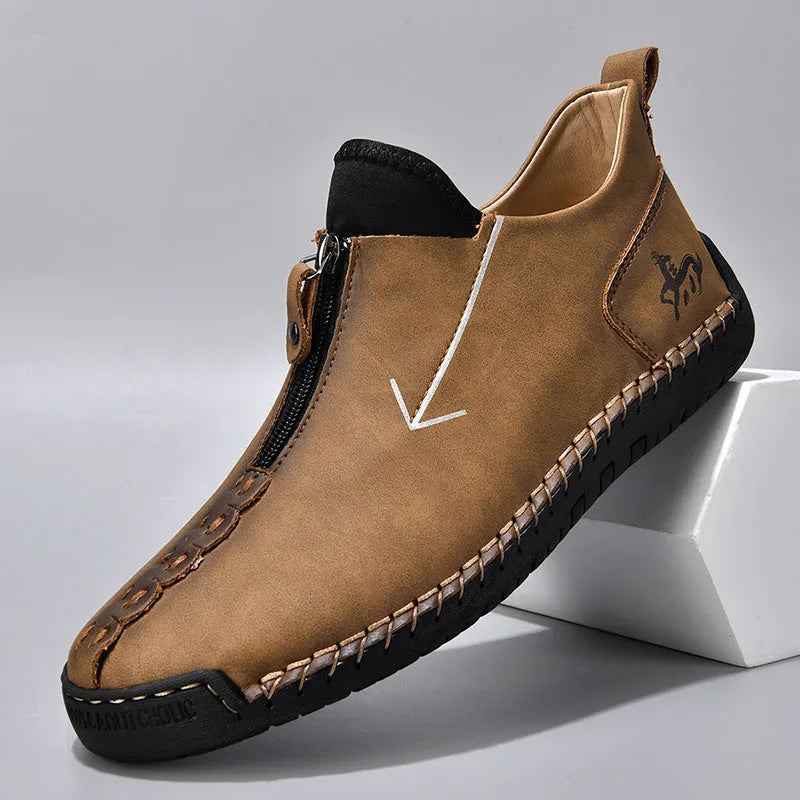 Men's black leather martin boots with a front metal zipper and round toe on a rubber sole.