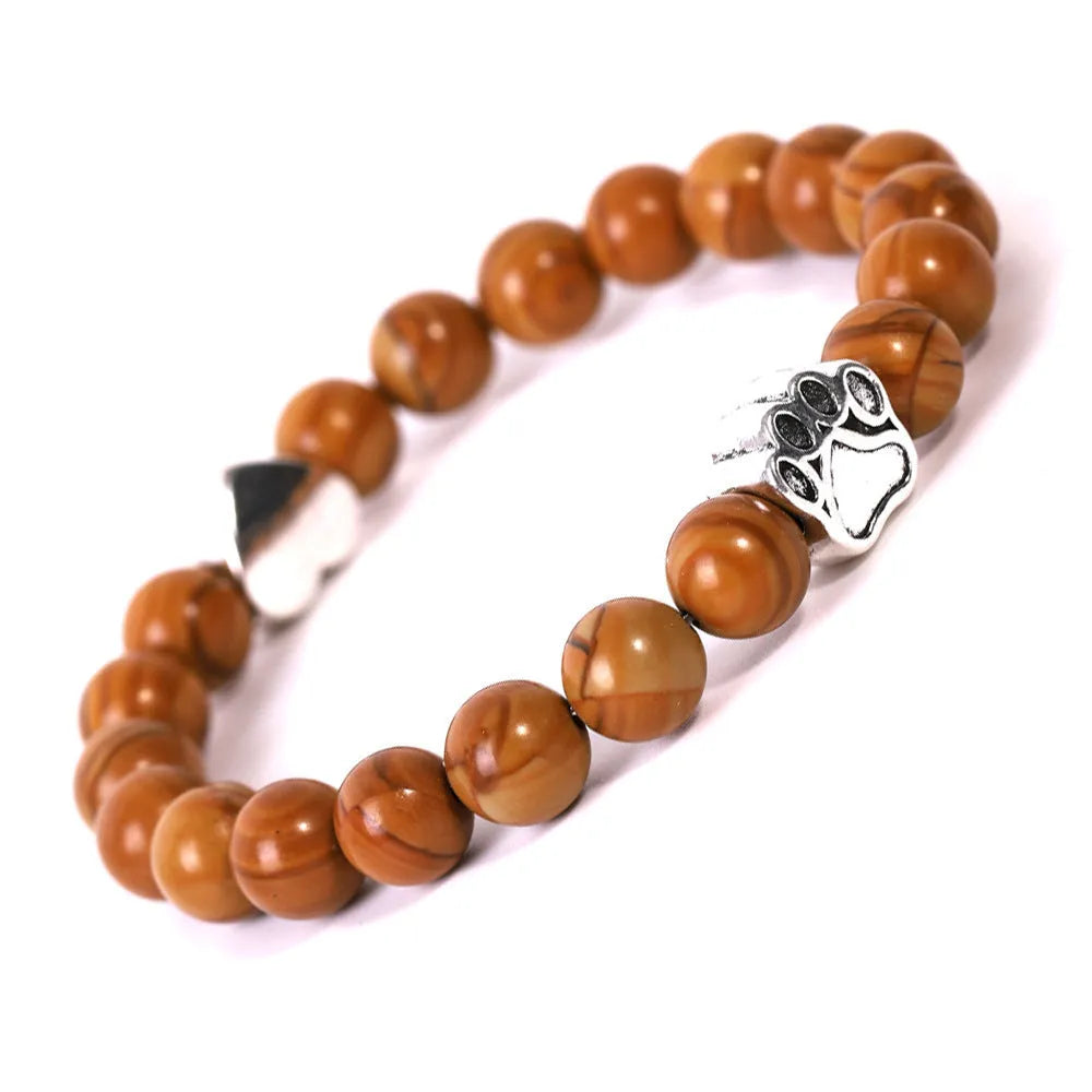 Tigereye and Indian agate stone beaded bracelet with a silver dog's paw charm and a geometric peach heart charm on a white background.