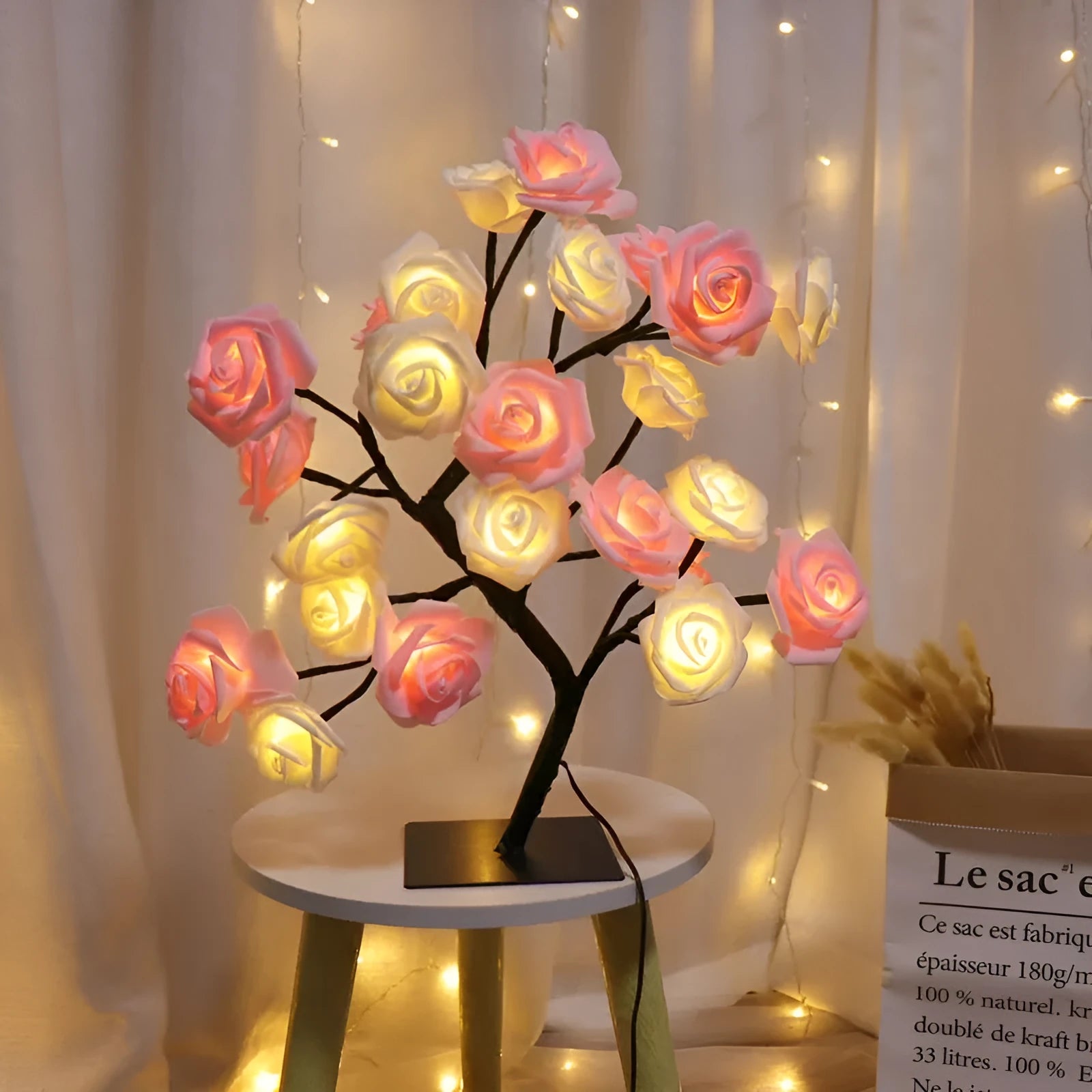Rose tree lamp with artificial pink blooms on a black square base with USB cable