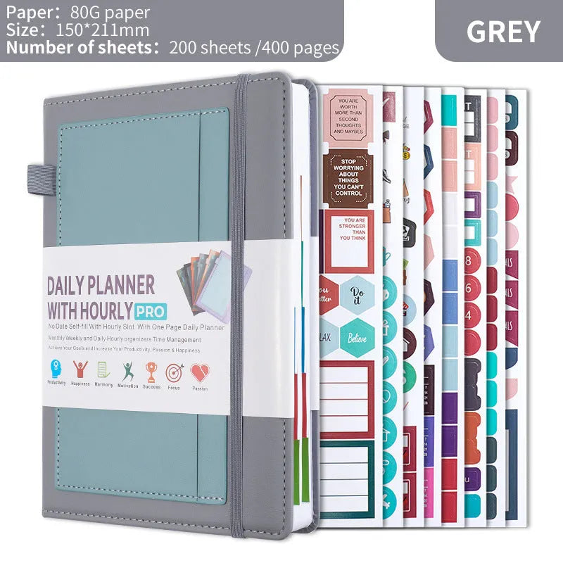 A5 notebook with PU leather cover in various colours, shown open to reveal blank pages and planning stickers.