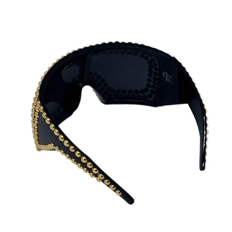 Men's punk style sunglasses with a large square frame and silver rivet details
