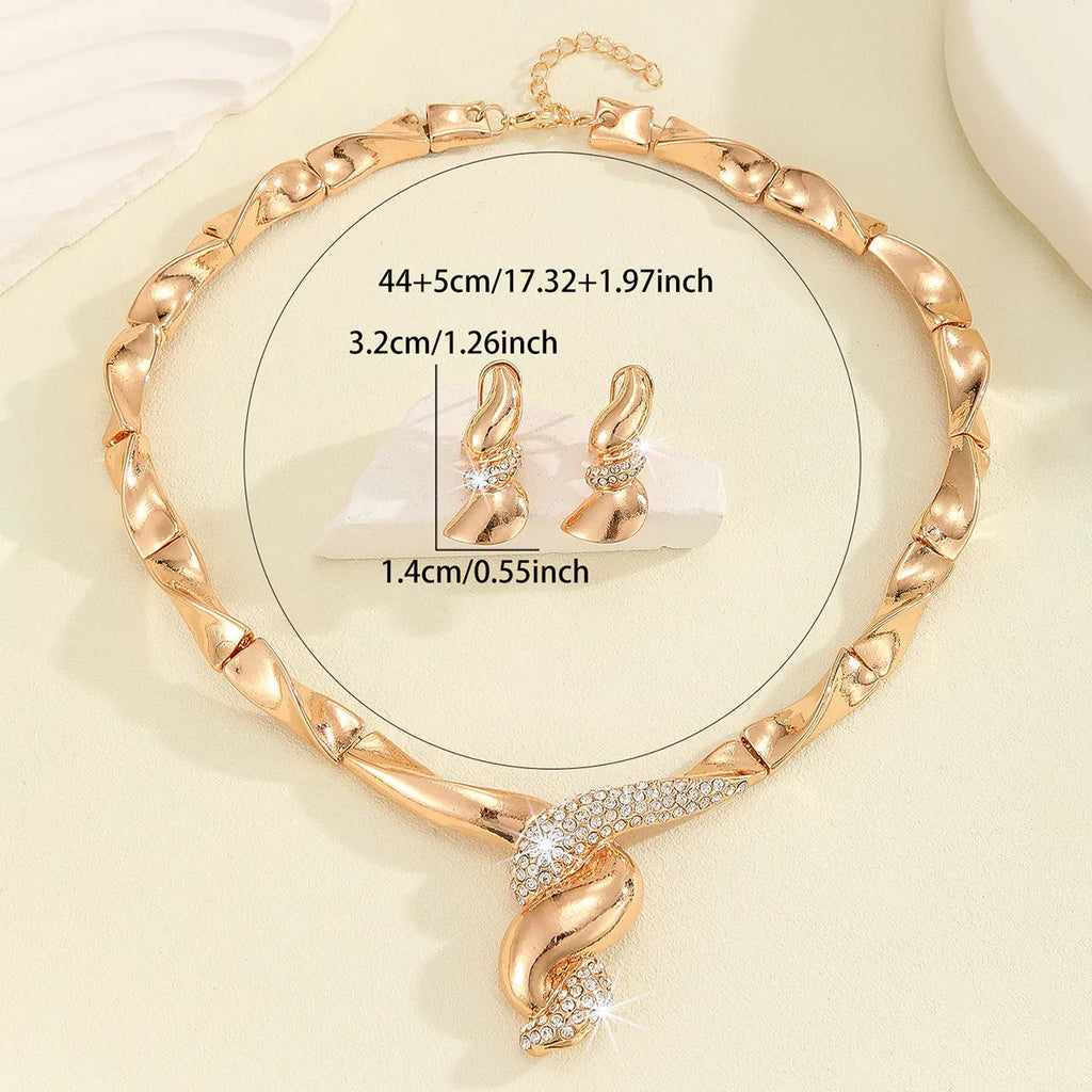 Gold alloy thread necklace and earrings suite with love heart pattern on a white background