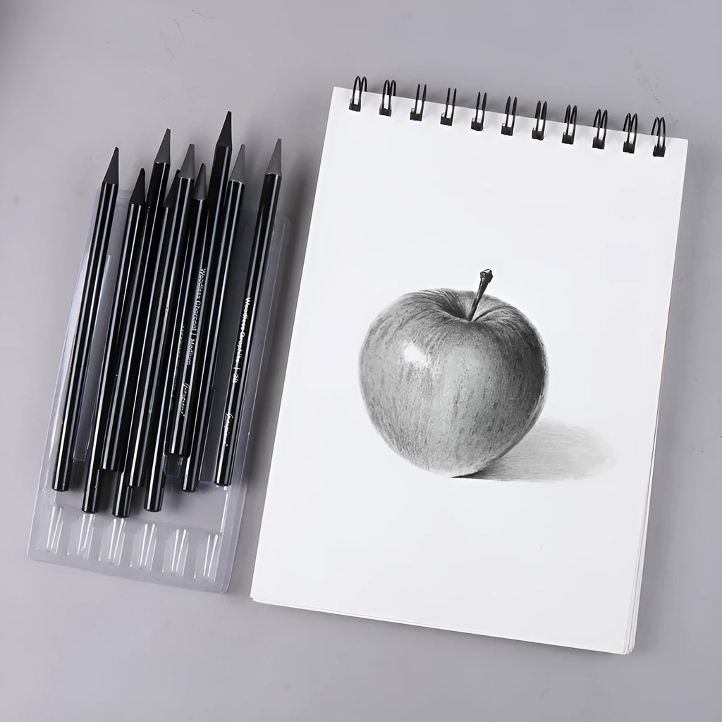 Set of nine graphite and carbonised drawing pencils in wooden casings on a suction card.