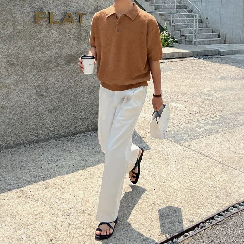 Men's caramel coloured retro knitted polo shirt with short sleeves and an asymmetrical design detail, laid flat.