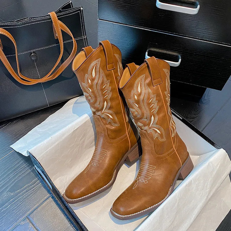 Brown embroidered women's mid-calf Martin boots with a square heel on a white background.