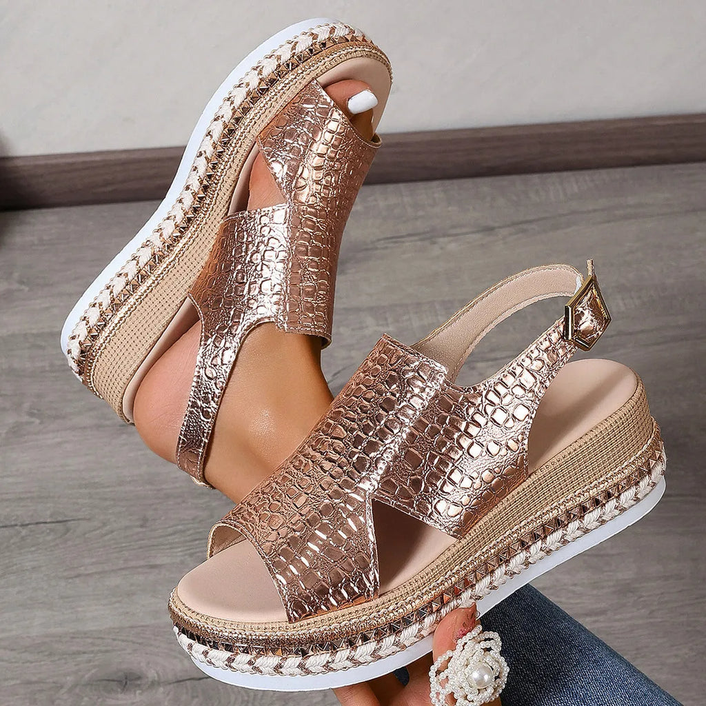 Gold women's Roman sandals with round hollow-out toe and an ankle buckle strap on a rubber sole.