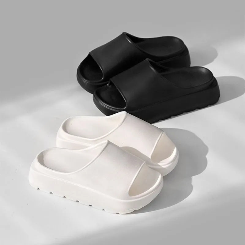 Women's beige fish mouth style EVA slippers with a thick sole, shown on a sandy beach background.