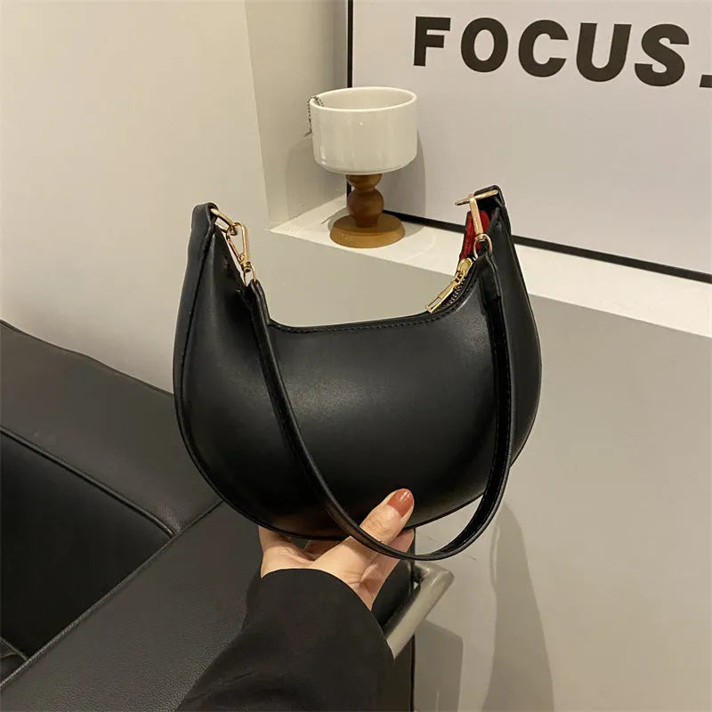 Round green one-shoulder underarm bag showing sewing line detailing and sandwich pocket design