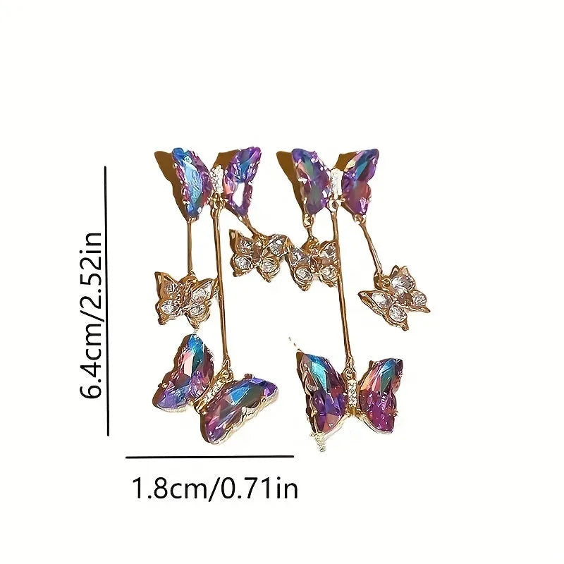 A pair of blue purple butterfly tassel earrings with silver needle crystal flowers on alloy posts.