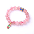 Pink strawberry quartz crystal bracelet with Ruyi charm and hand-woven design for women.