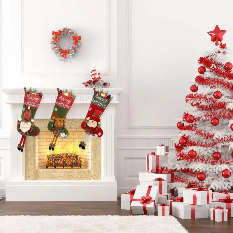 Three large Christmas stockings with 3D Santa, snowman, and reindeer designs hung on tree