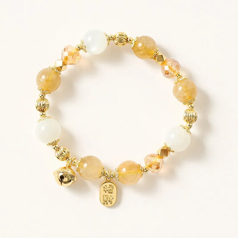 Adjustable gold tone bracelet with rutilated quartz crystal centrepiece and electroplated metal components