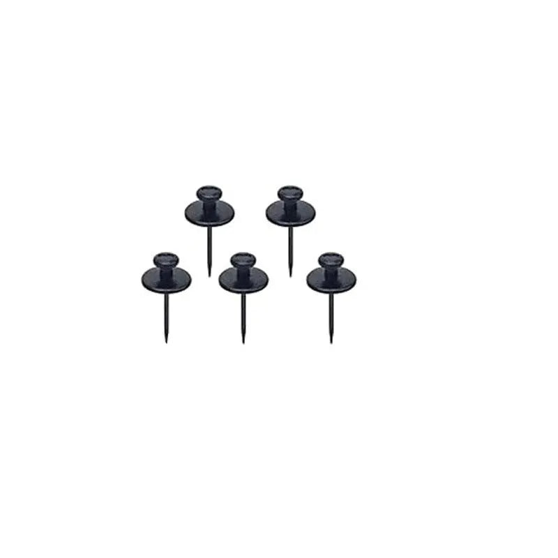 Fancy thumb tack set in mixed colours black gold silver bronze on a corkboard surface