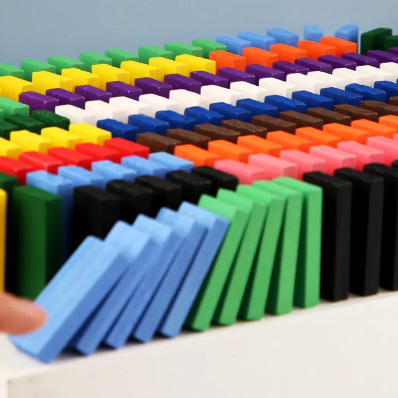 120-piece rainbow wooden domino blocks from pine wood with water-based paint on a flat surface