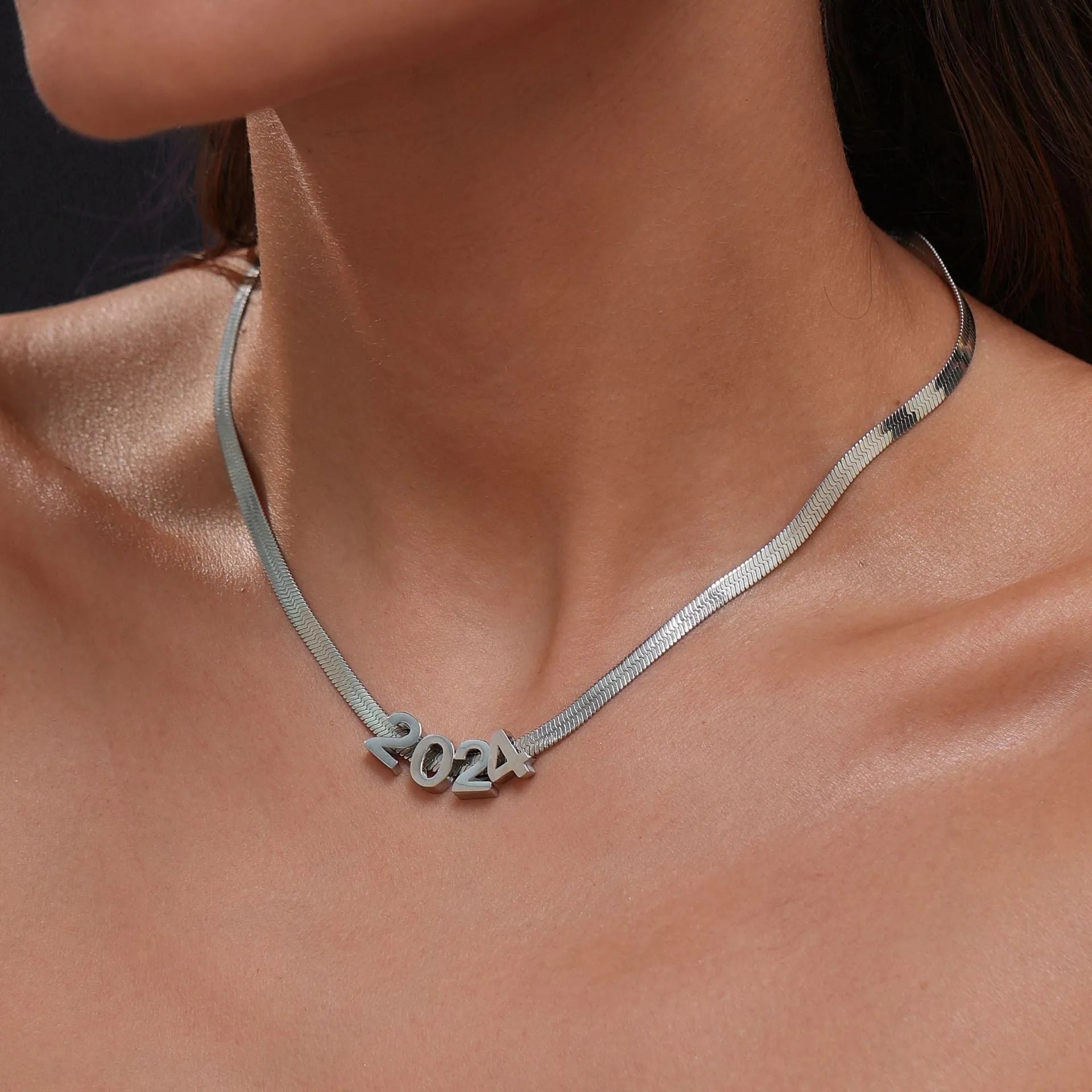 Gold or silver plated titanium steel necklace with a personalised letter, number, or heart pendant on a 40.5cm chain.