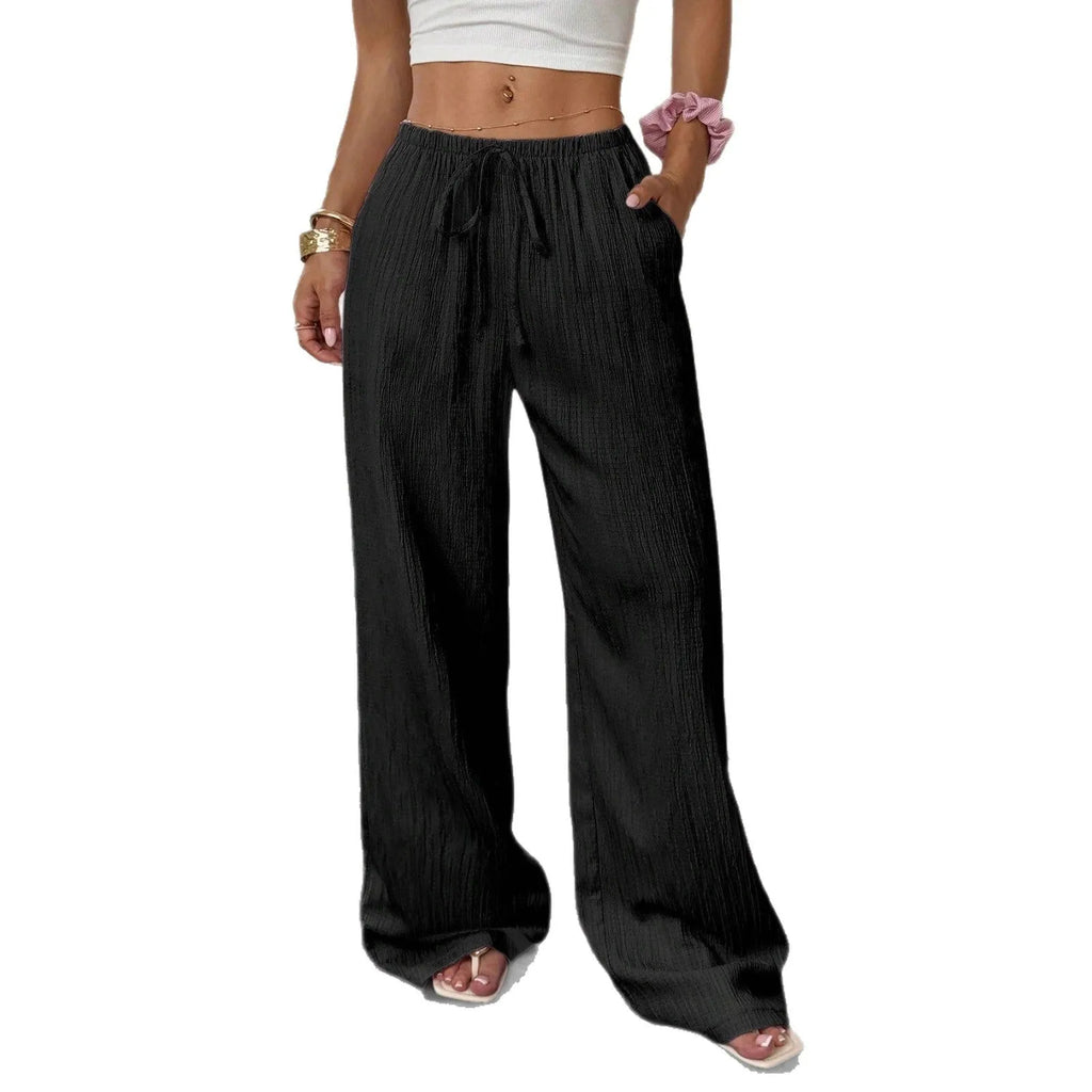 Women's black wide-leg trousers with a front lace-up waist detail on a mannequin.