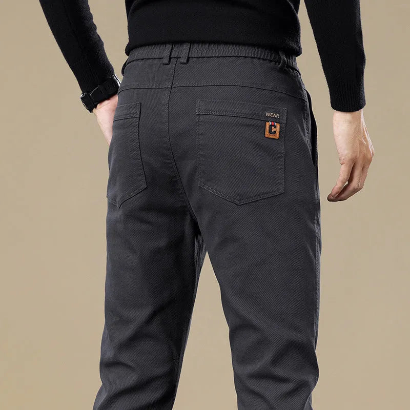 Men's fleece-lined slim fit tapered casual pants in black cotton fabric with straight leg