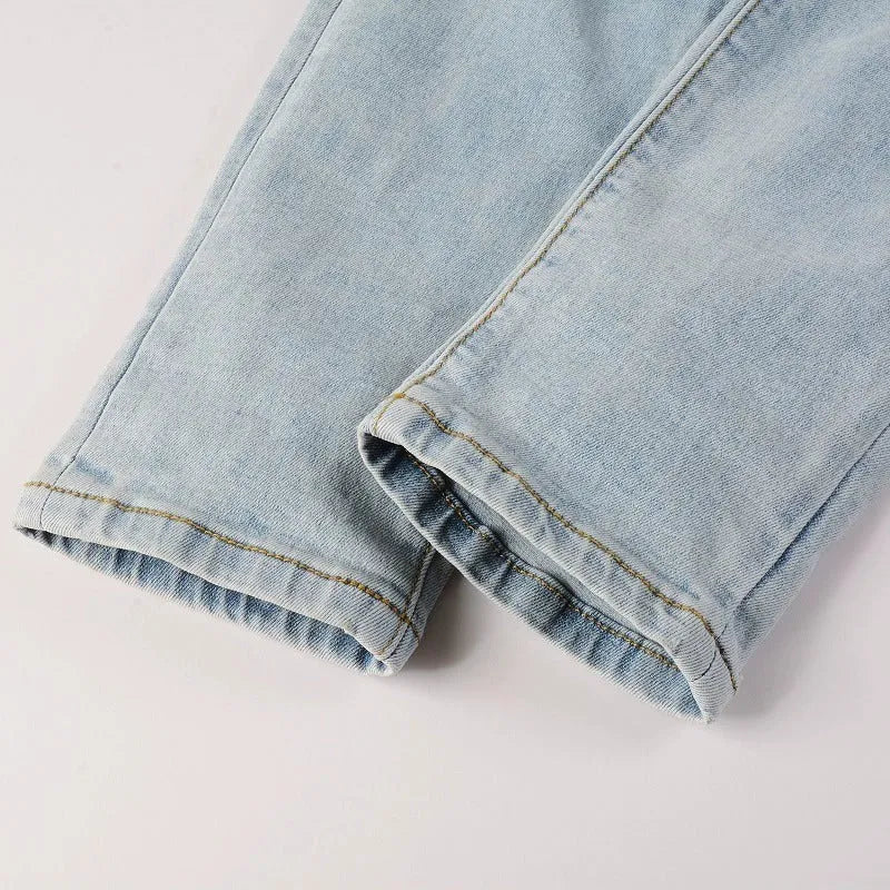 Light blue slim fit stretch jeans for men with hot diamond patch and cat-whisker details