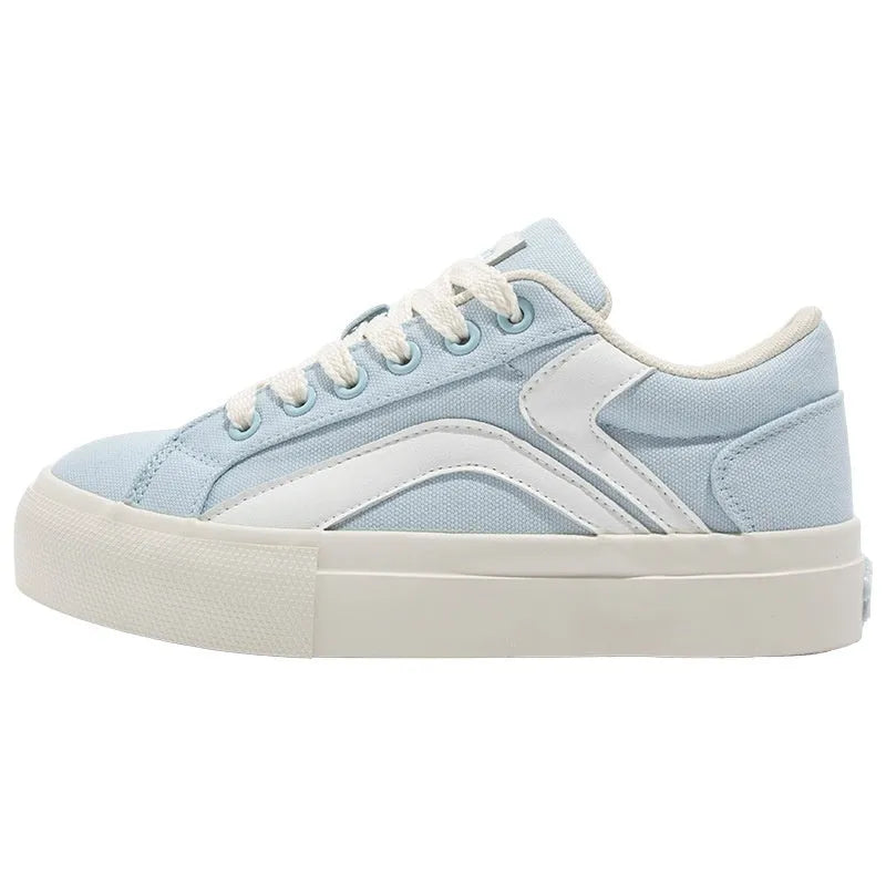 Women's blue and white vulcanised board shoes with a low-top lace-up design and round toe.